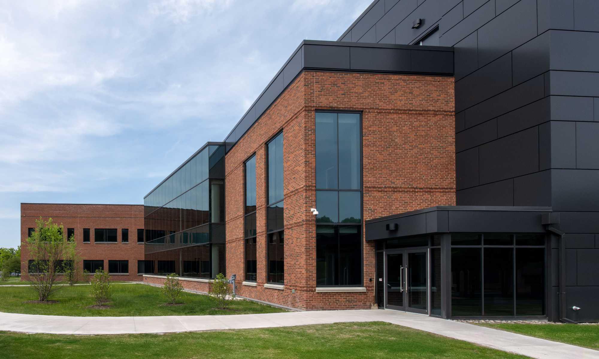 Exterior of the Laboratory for Laser Energetics building expansion against a blue sky.